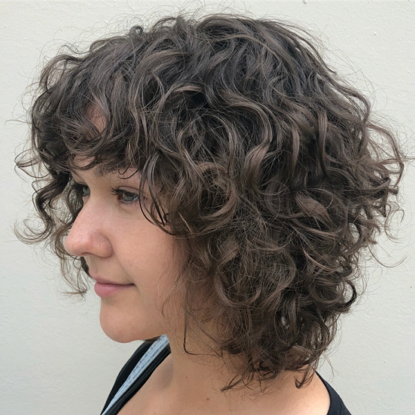step cut medium length hair curly hair bangs