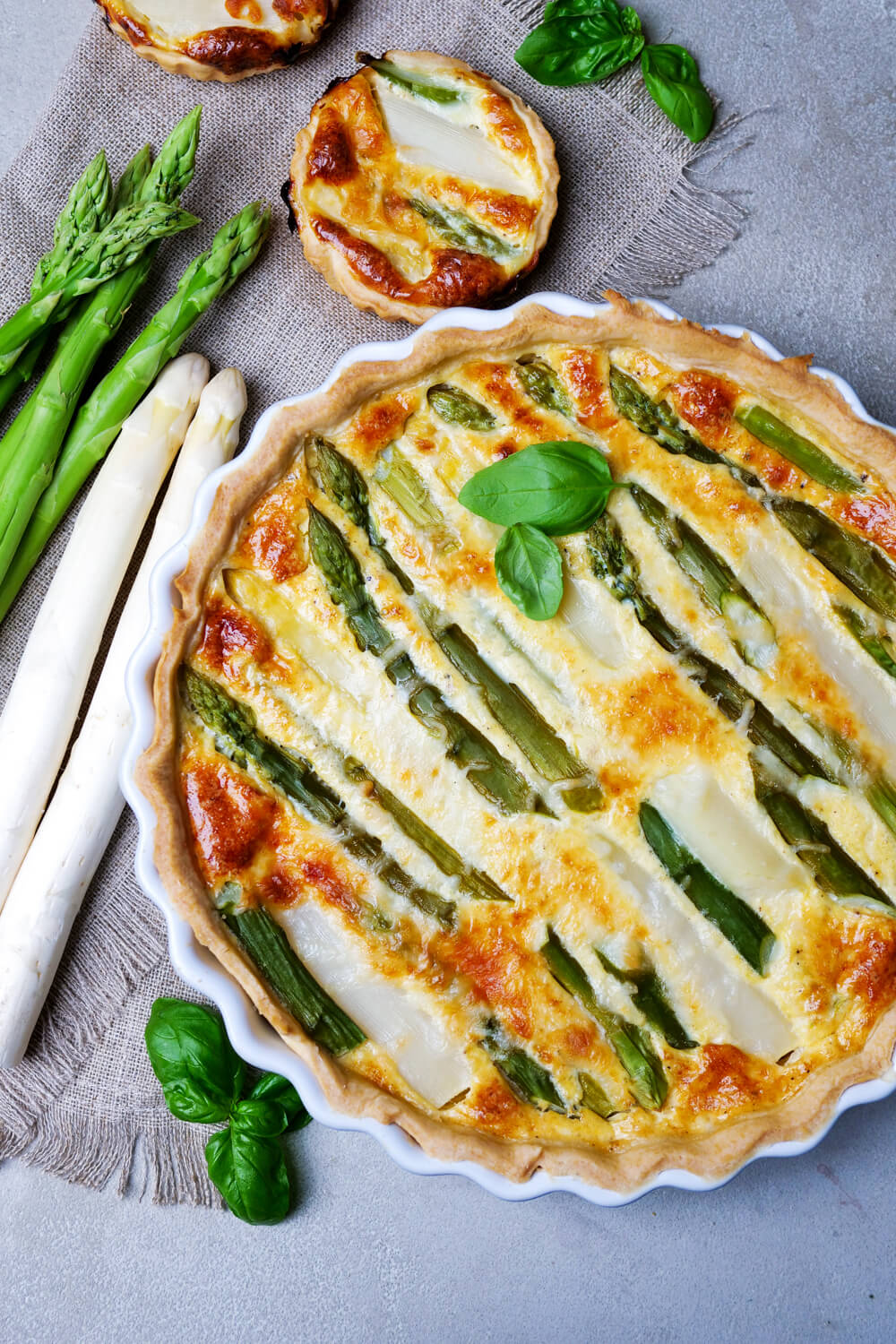 Asparagus quiche with white and green asparagus in the quiche form