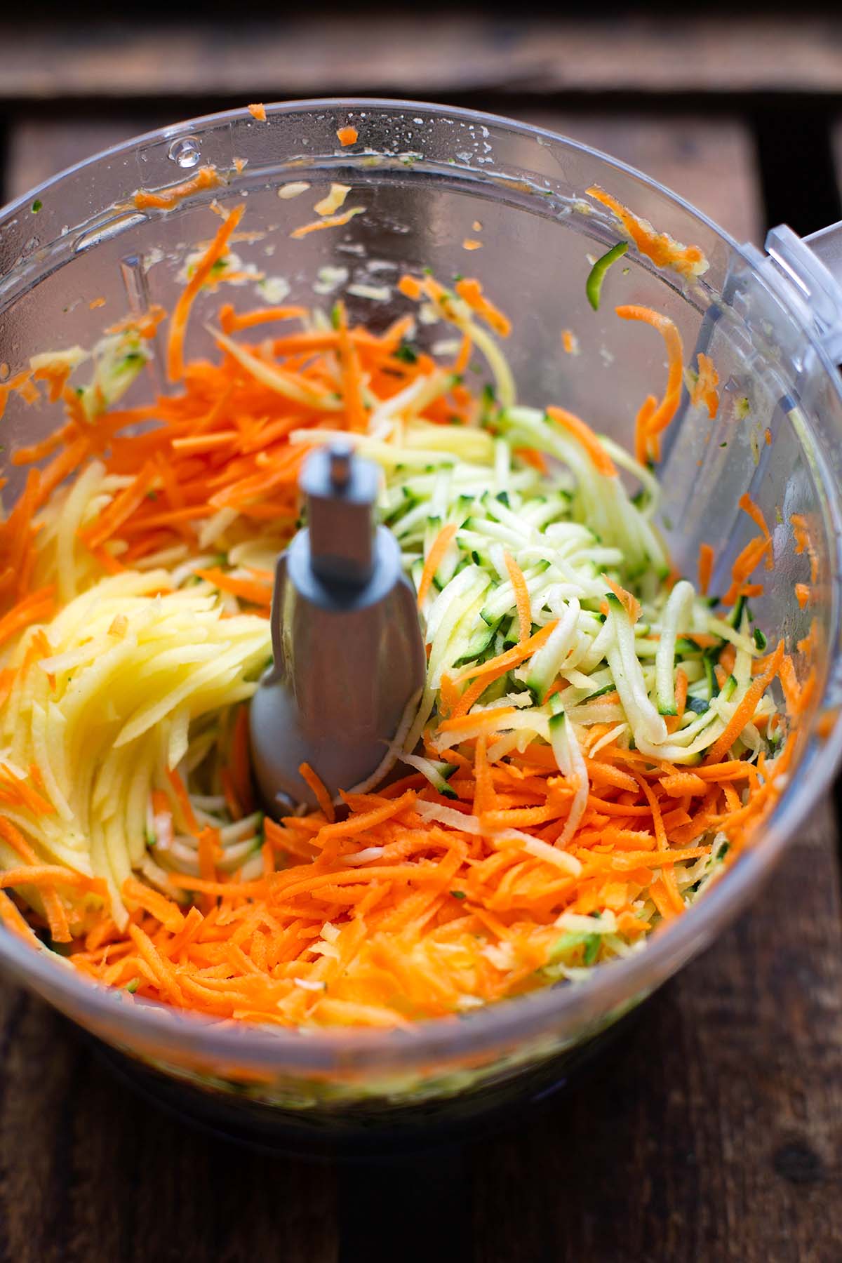 Raid vegetables such as potatoes, carrots and zucchini in a food processor.
