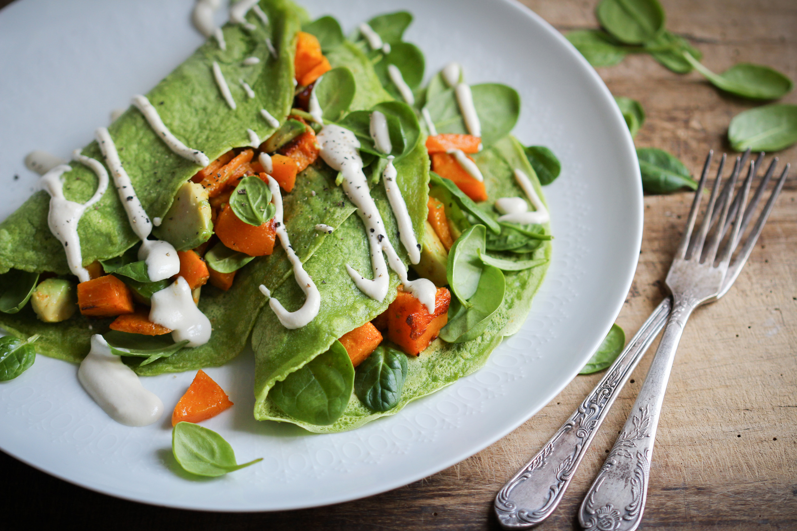 Vegan spinach pancakes with butternut and avocado
