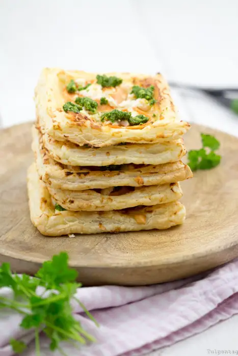Vegetarian snack for New Year's Eve or other celebrations and parties. Finger food in the form of puff pastry with sweet potato, feta and herbal pesto. Made easy and quick.