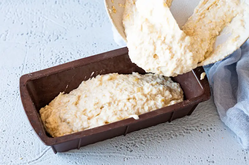 The banana bread dough is filled into a small box shape.