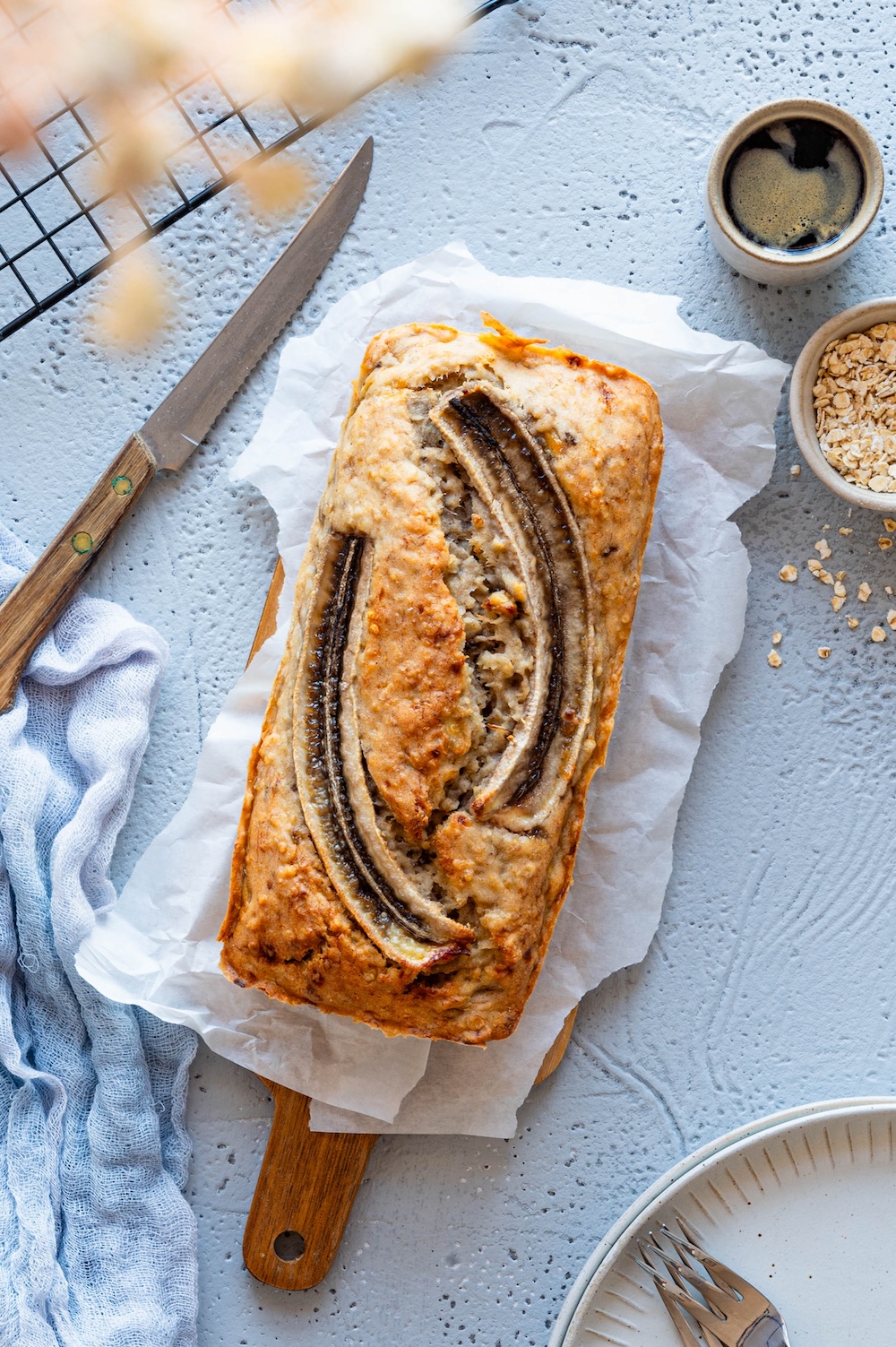Vegan's banana bread without sugar photographed on a wooden board from above.
