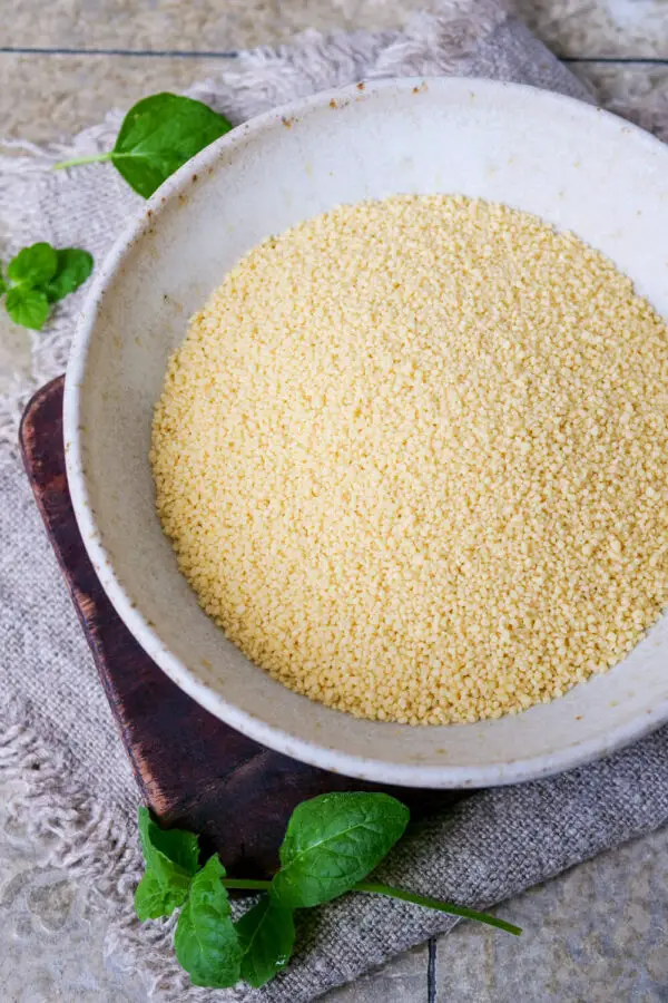 Raw couscous on a deep plate.
