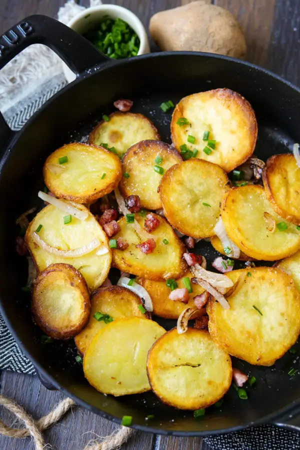 Crispy fried potatoes with onions and bacon in the pan