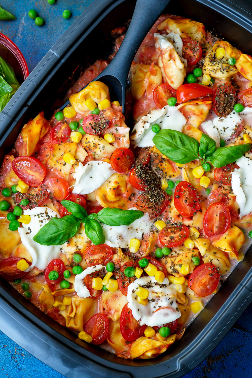 Tortellini run with tomato sauce, corn, peas, tomatoes and mozzarella