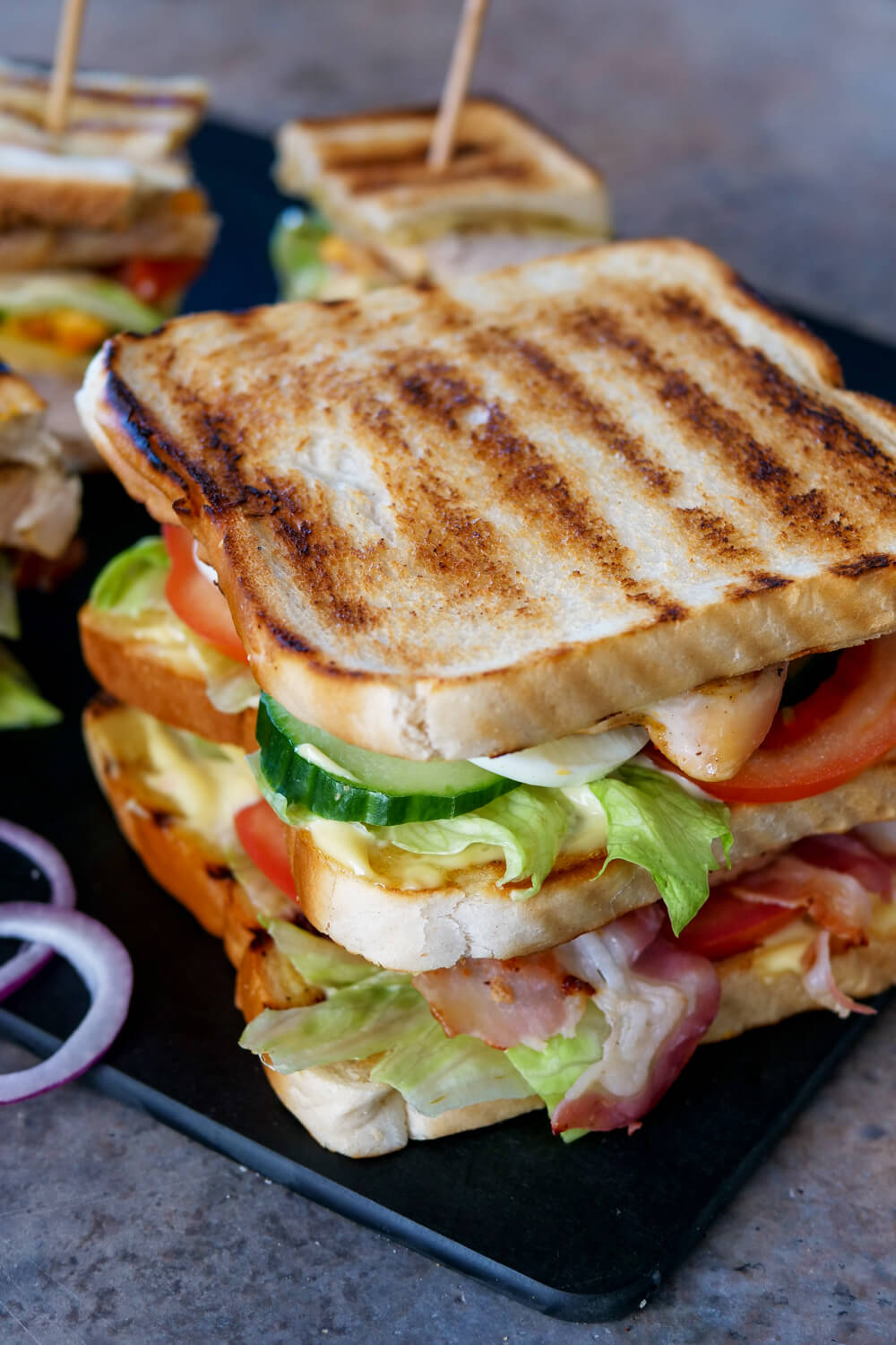Club sandwich recipe with turkey, bacon, cucumbers, tomatoes and egg