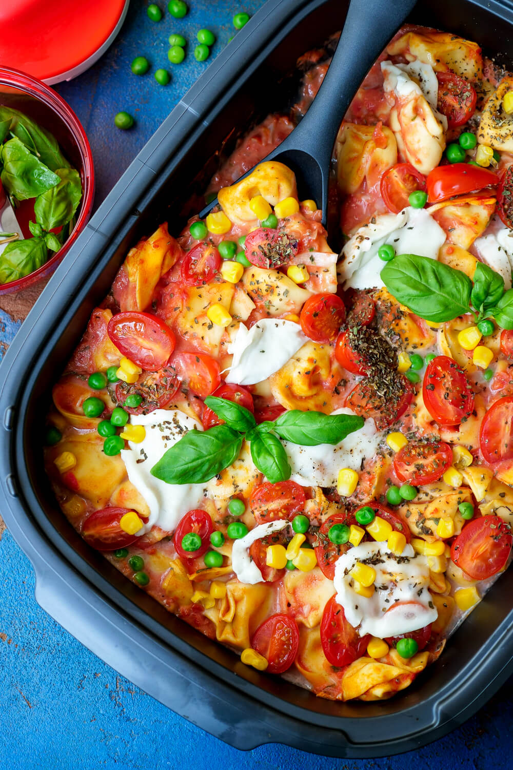 Vegetarian tortelini run with tomatoes, corn, peas and mozzarella