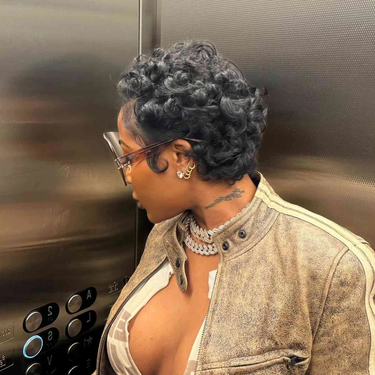 Woman cut curly dark hair short