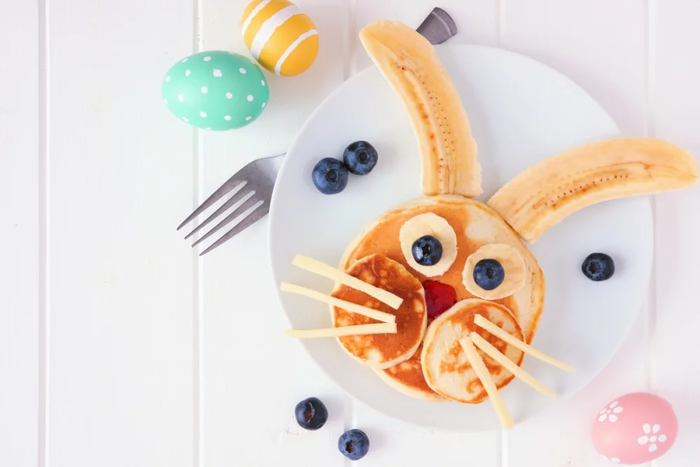 Ears made of bananas and rabbit eyes made of blueberries - Easter breakfast with pancakes