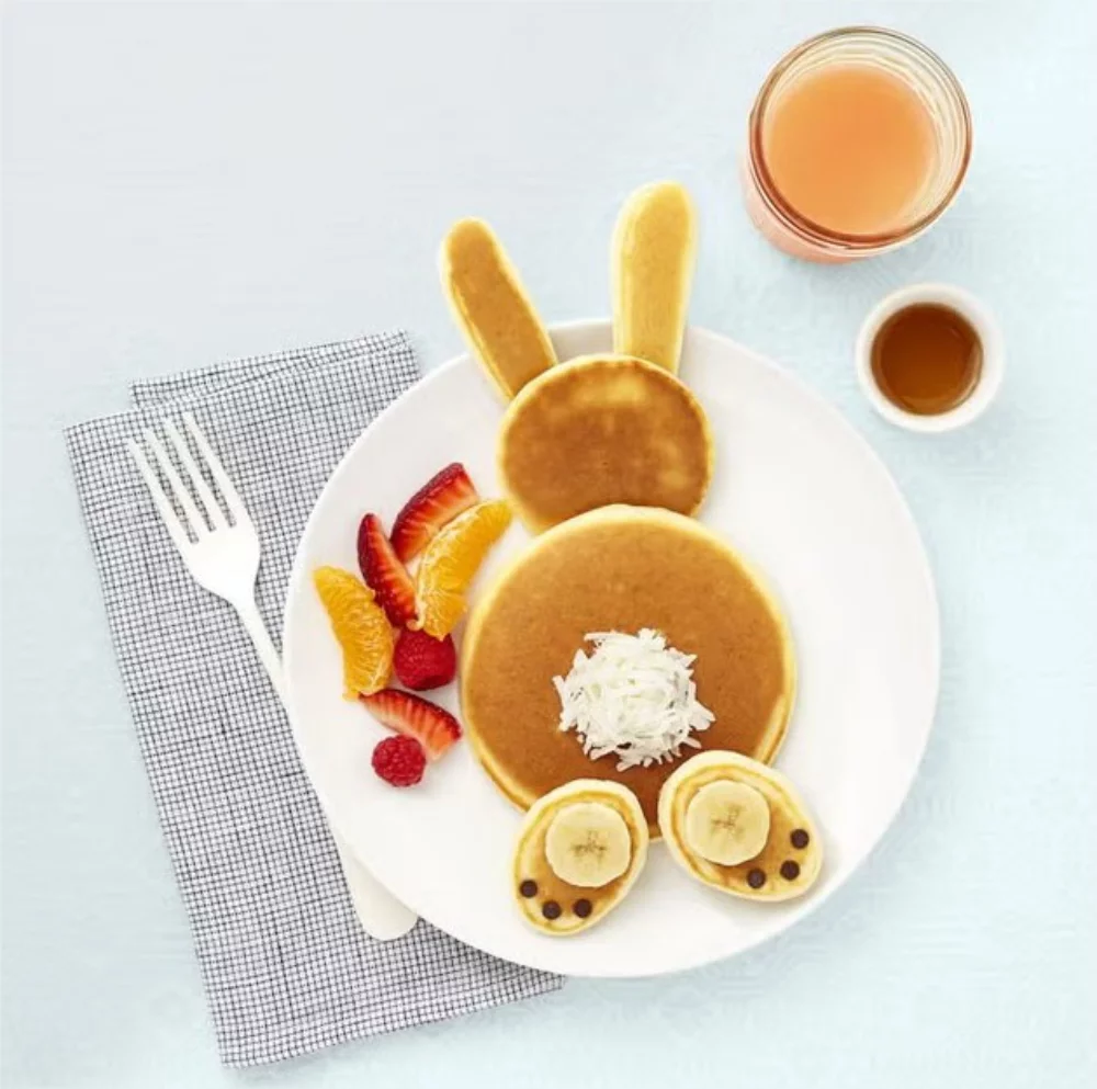 Pancakes as an Easter bunny with fresh fruits on the plate