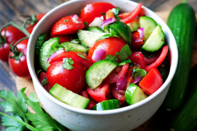 Tomato cucumber salad with red onion and dressing