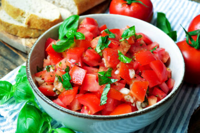 Tomato salad with onions and basil in the bowl